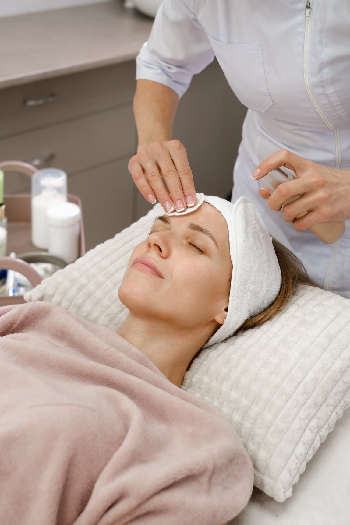 Woman Applies Tonic, Cleaning Skin Procedure in Aesthetic Clinic